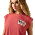 Woman wearing a red sleeveless top with an American flag design on a white background