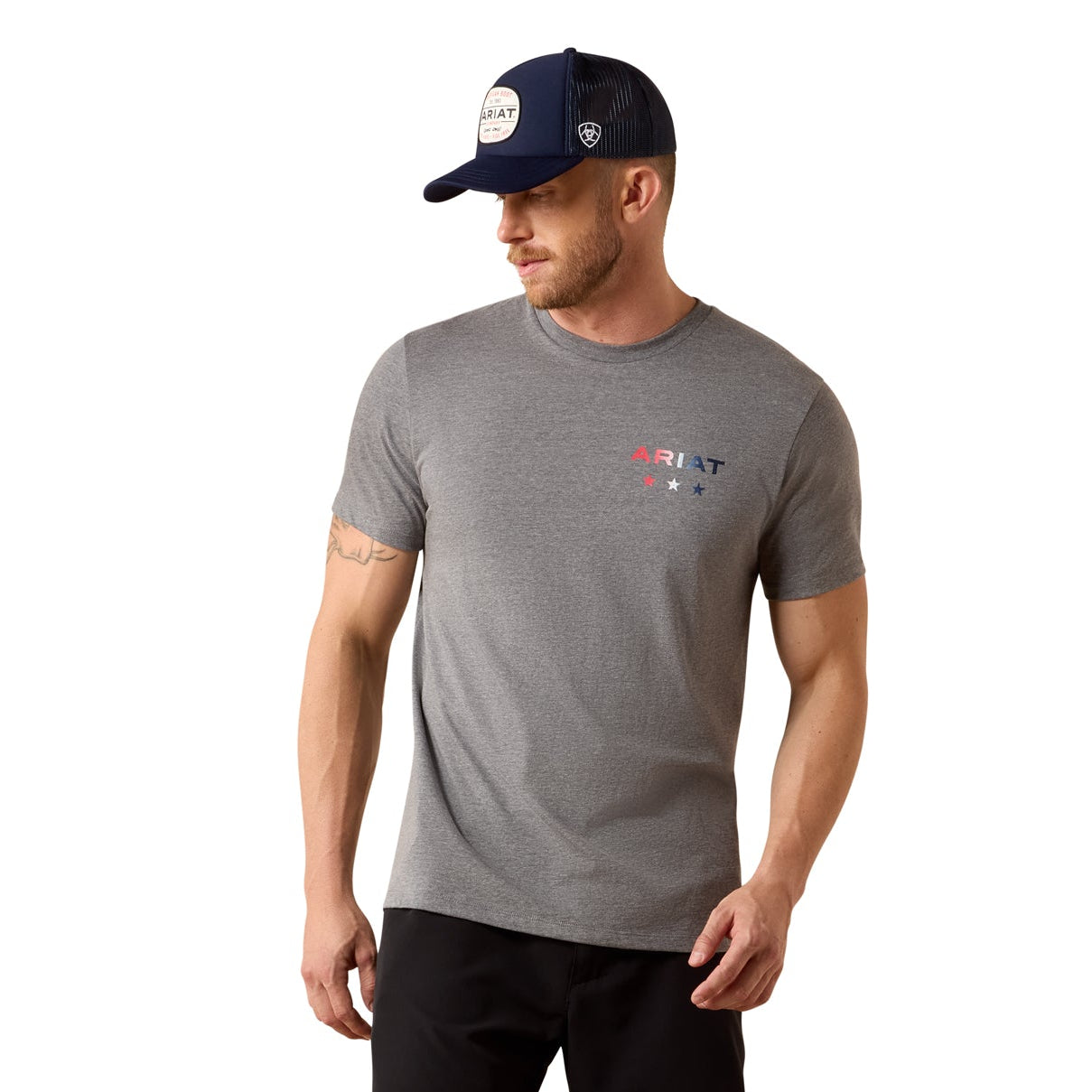 Man wearing a gray t-shirt, black shorts, and a navy cap on a white background