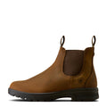 Tan leather Chelsea boot with black sole on a white background, side view