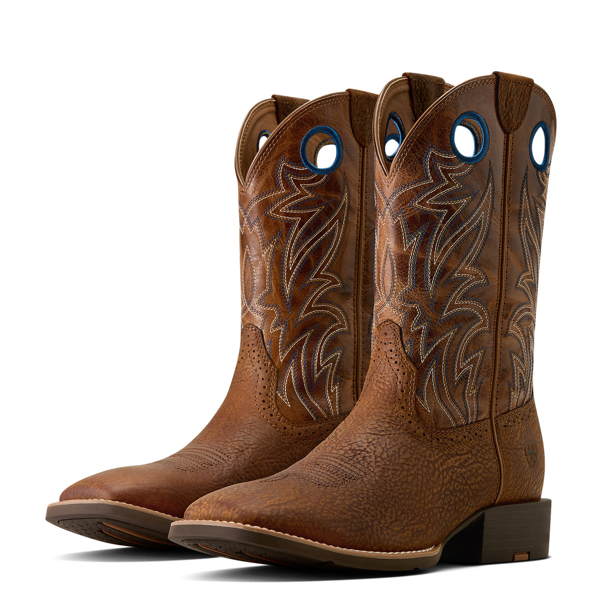 Pair of brown cowboy boots with intricate designs on a white background