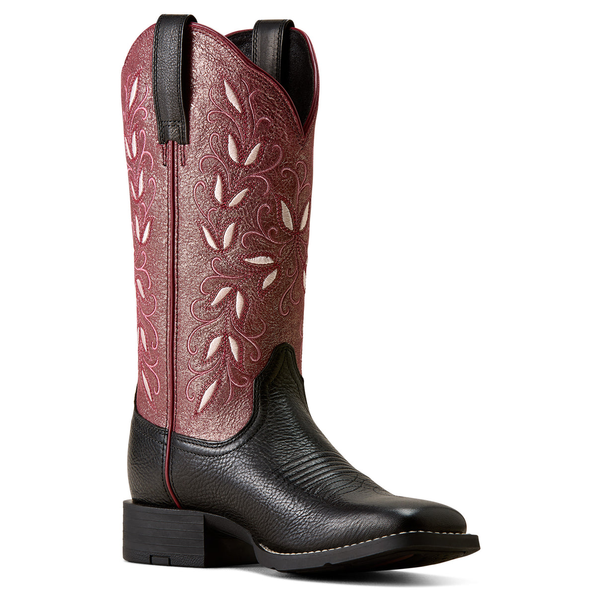 A single western cowboy boot shown in a side profile on a white background. The shaft is a dusty rose pink leather with white floral embroidery, while the foot and pull tabs are black leather.