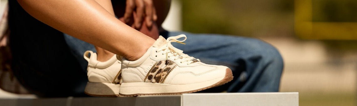 Ariat Ranch Runner - New Casual Footwear with a nostalgic, cool vibe worn by female model close up on shoes.