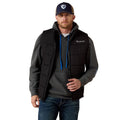 Man wearing a black jacket with a visible brand logo on a white background