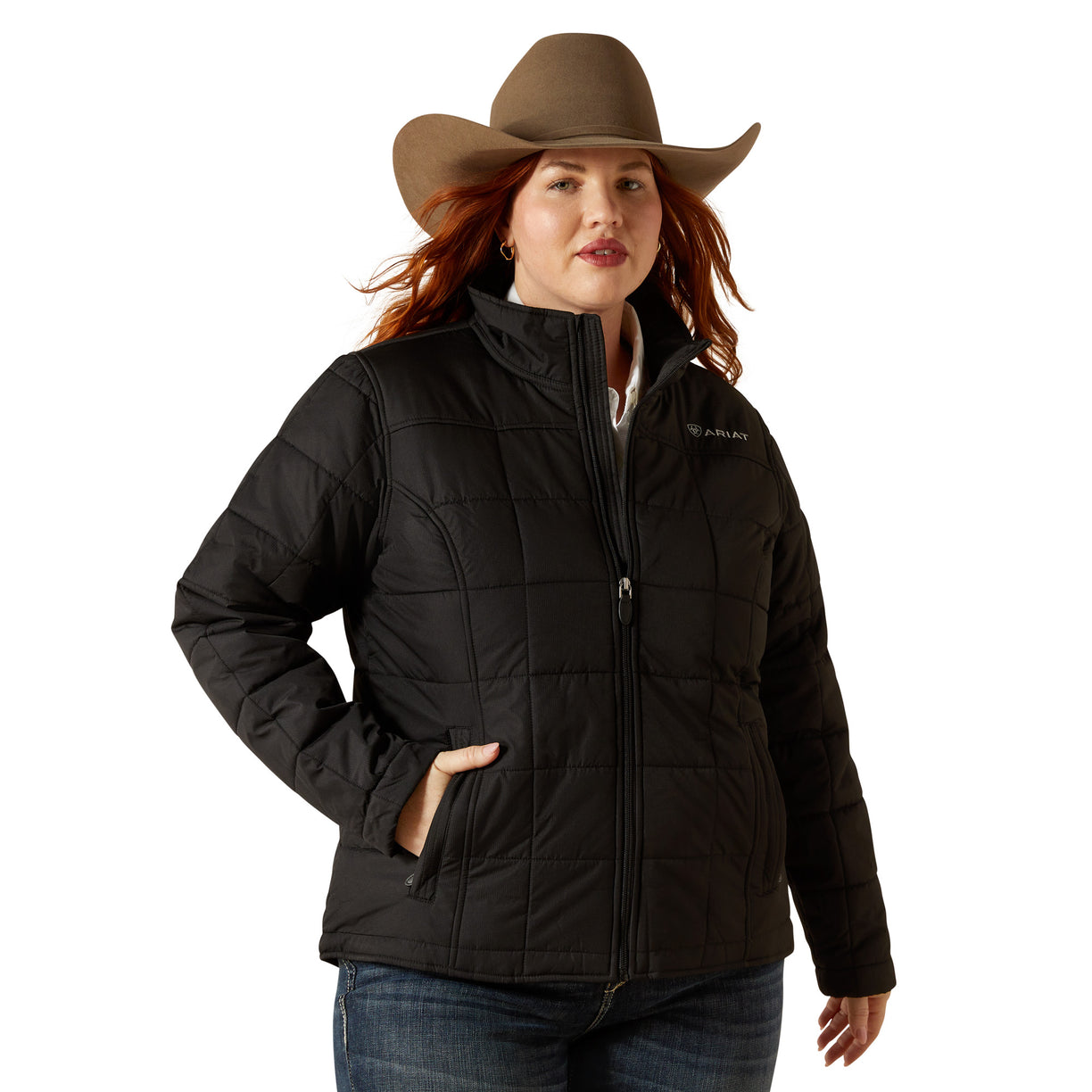 Woman wearing a black jacket and brown cowboy hat on a beige background