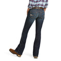 Person wearing blue jeans and a plaid shirt on a white background