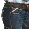 Close-up of blue jeans with a brown belt on a white background