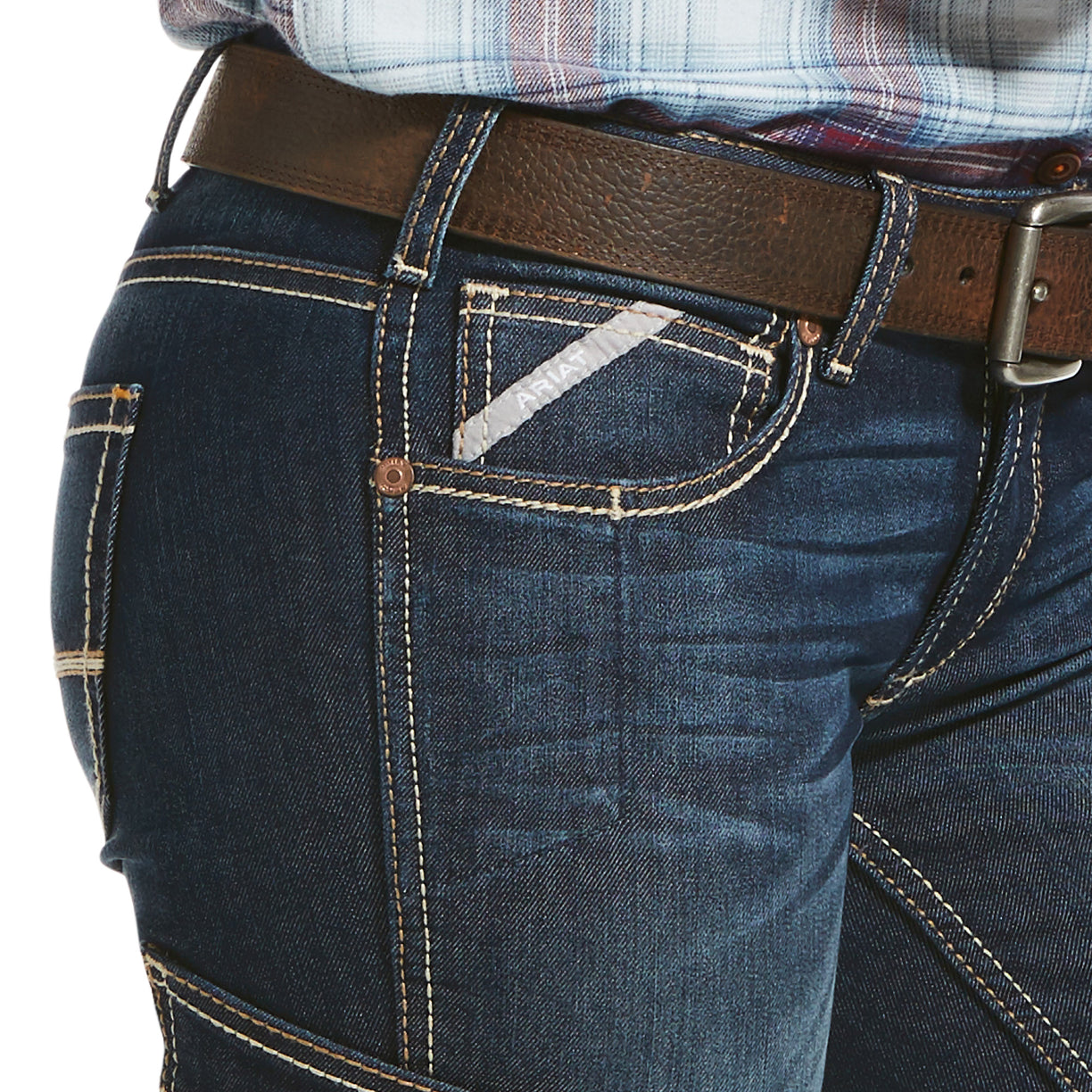 Close-up of blue jeans with a brown belt on a white background
