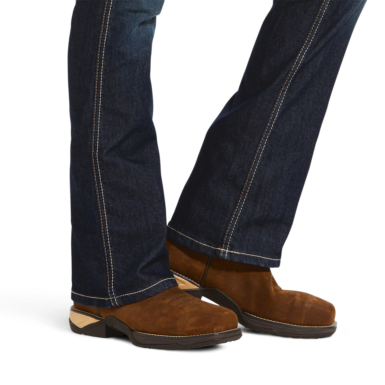 Brown suede shoes worn with dark blue jeans on a white background