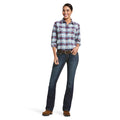 Woman wearing a plaid shirt and jeans on a white background