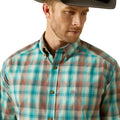 Man wearing a plaid shirt with a visible brand logo on a white background