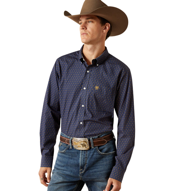 Man wearing a patterned shirt, jeans, and a cowboy hat on a white background