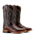 Pair of brown cowboy boots with intricate designs on a white background
