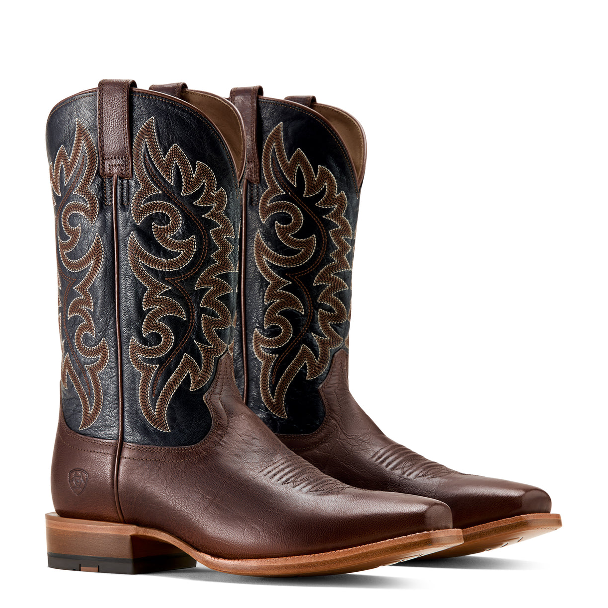 Pair of brown cowboy boots with intricate designs on a white background