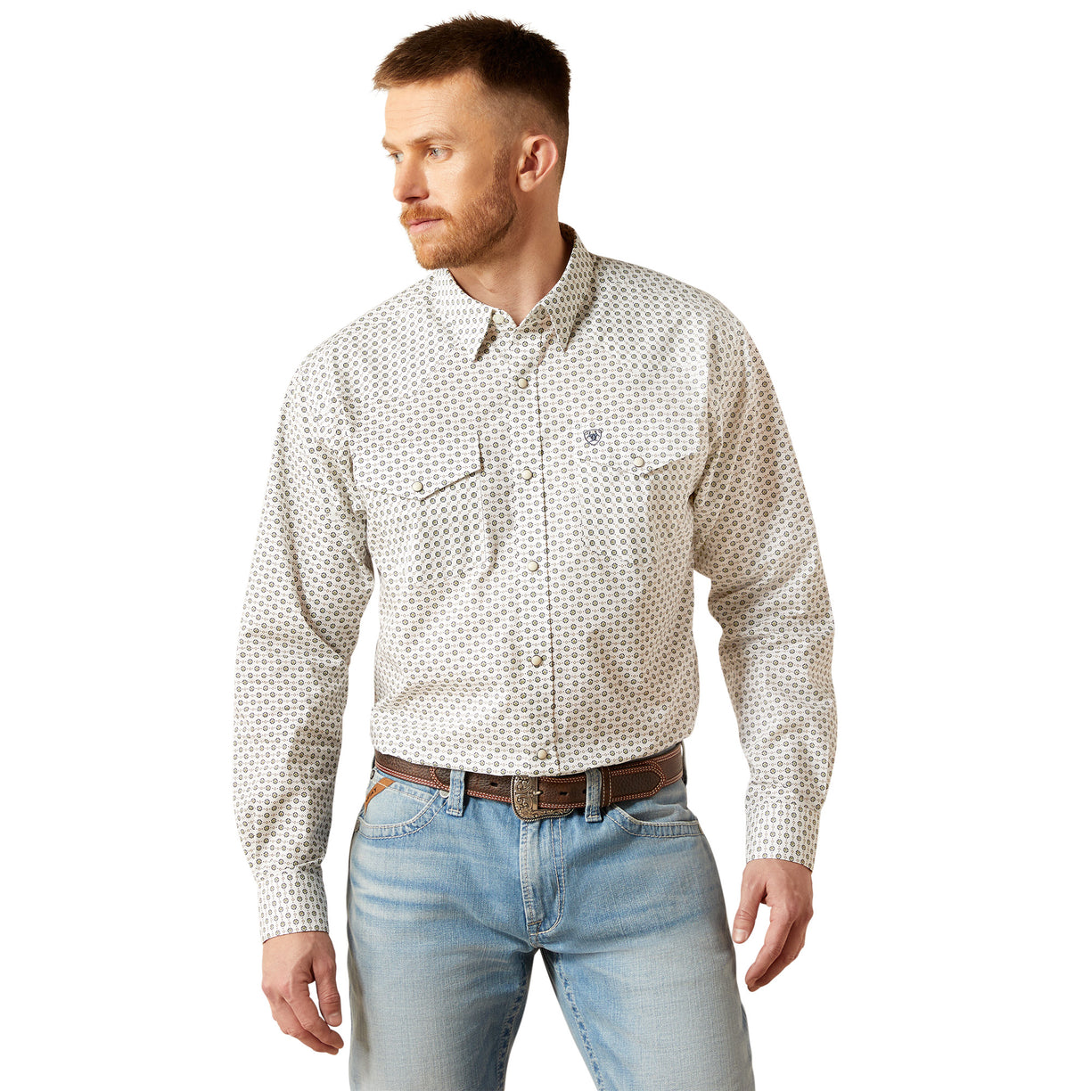 Man wearing a patterned shirt and jeans on a white background