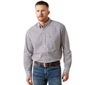 Man wearing a patterned shirt and jeans on a white background