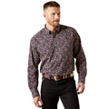 Man wearing a patterned shirt and black pants on a white background