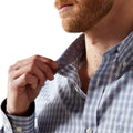 Man adjusting his collar with a white background