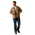 Man wearing a tan jacket and blue jeans on a white background