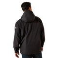 Person wearing a black jacket with a visible brand logo on the sleeve against a white background