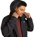 Man wearing a black jacket with a brand logo on a white background