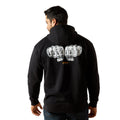 Person wearing a black hoodie with text on the back against a white background