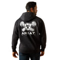 Person wearing a black hoodie with Ariat logo on the back