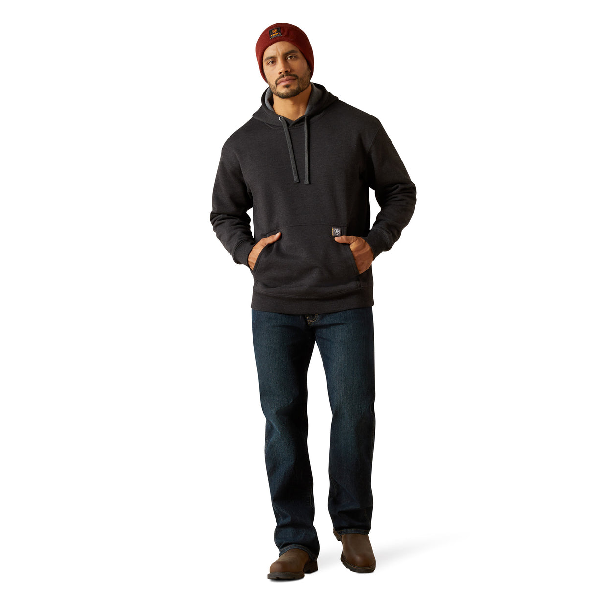 Man wearing a dark hoodie and jeans on a white background