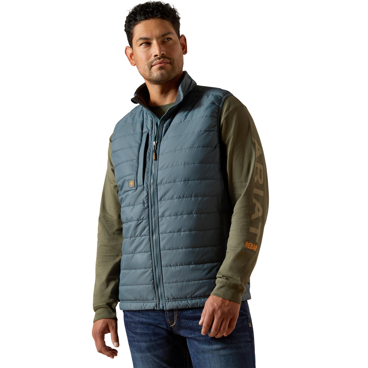 Man wearing a blue and green quilted vest with Carhartt logo on a white background