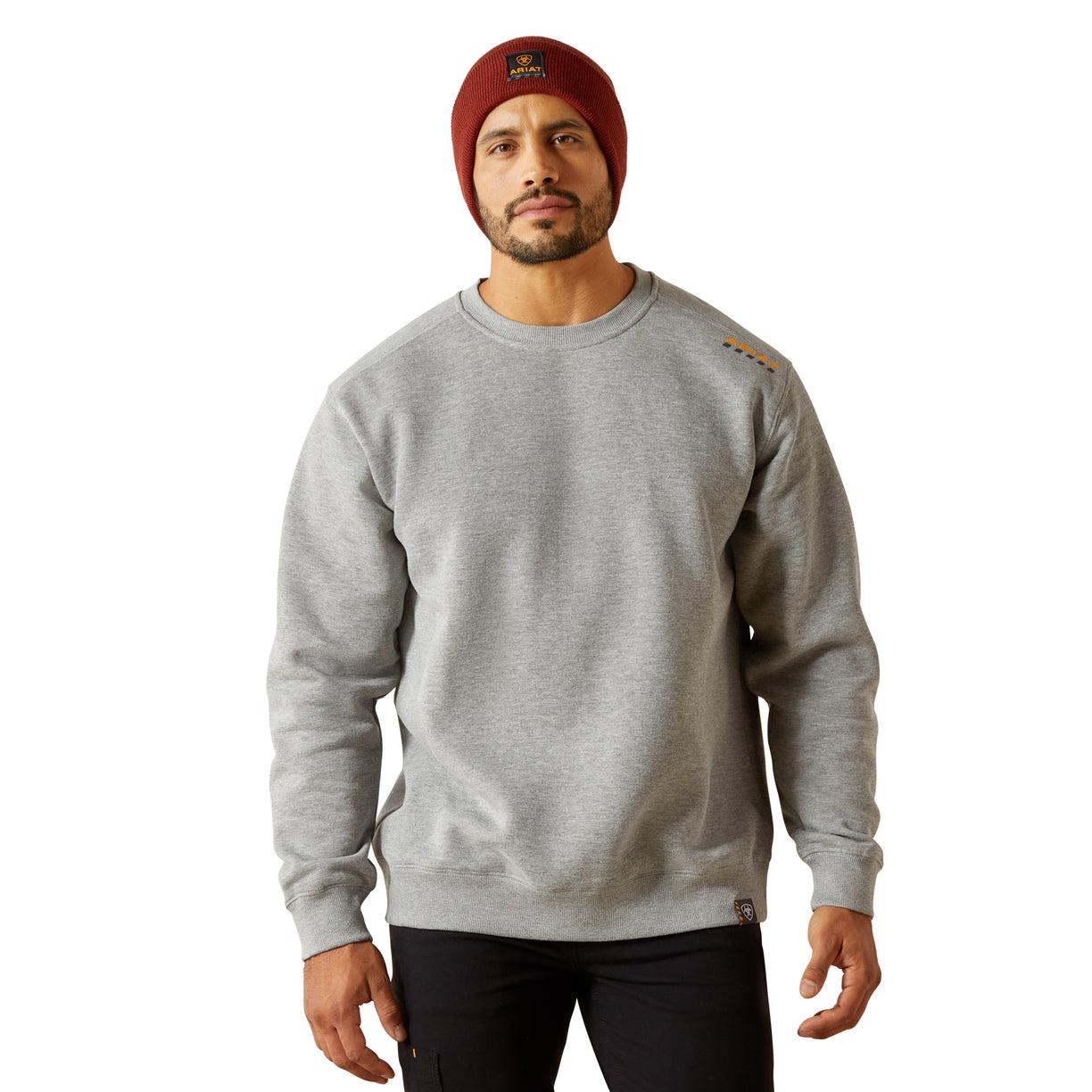 Man wearing a gray sweatshirt and red beanie on a white background