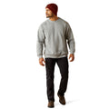 Man wearing a gray sweatshirt, black pants, and a red beanie on a white background