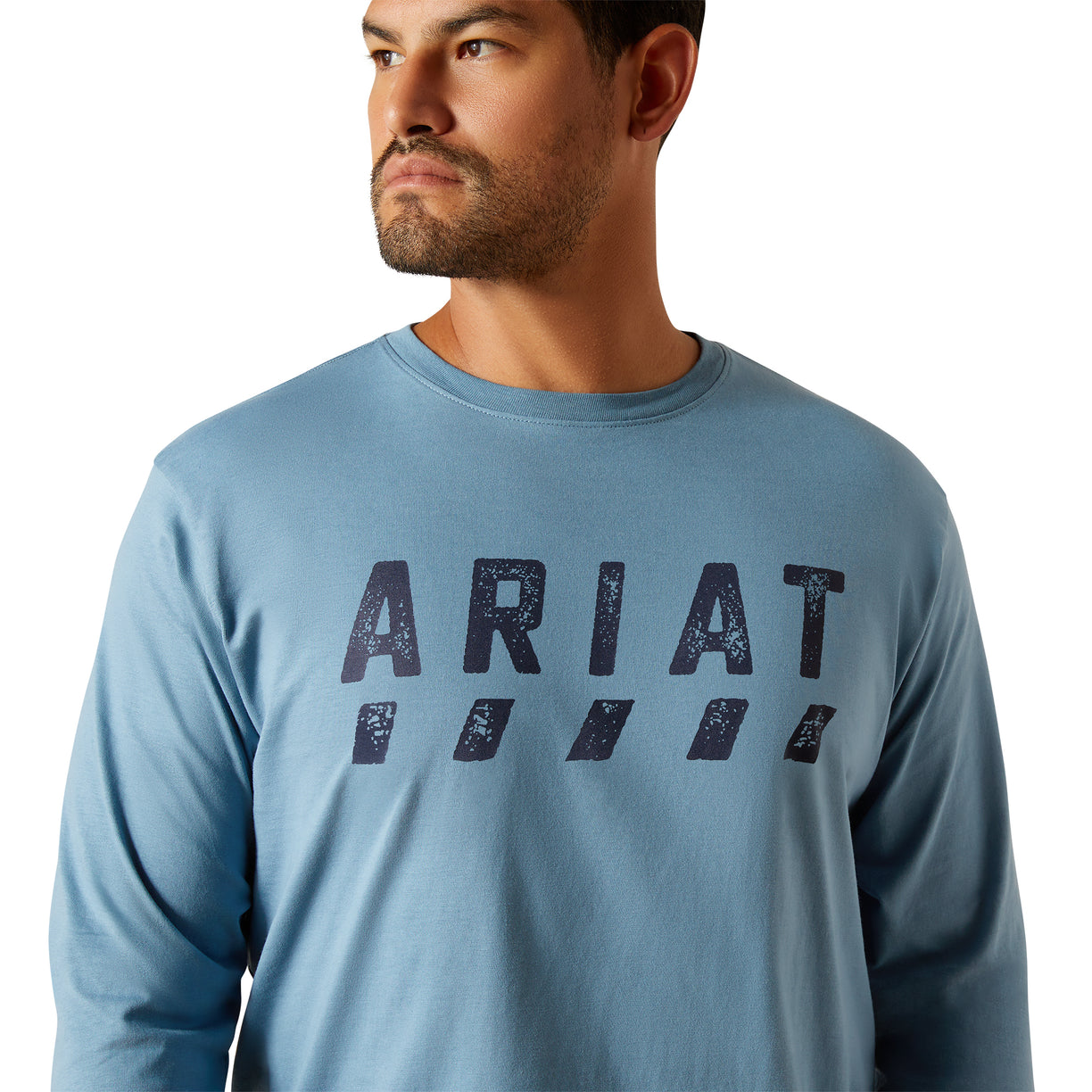 Man wearing a blue Ariat long-sleeve shirt on a white background