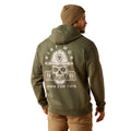 Person wearing a green hoodie with a skull design and text on the back, standing against a white background.