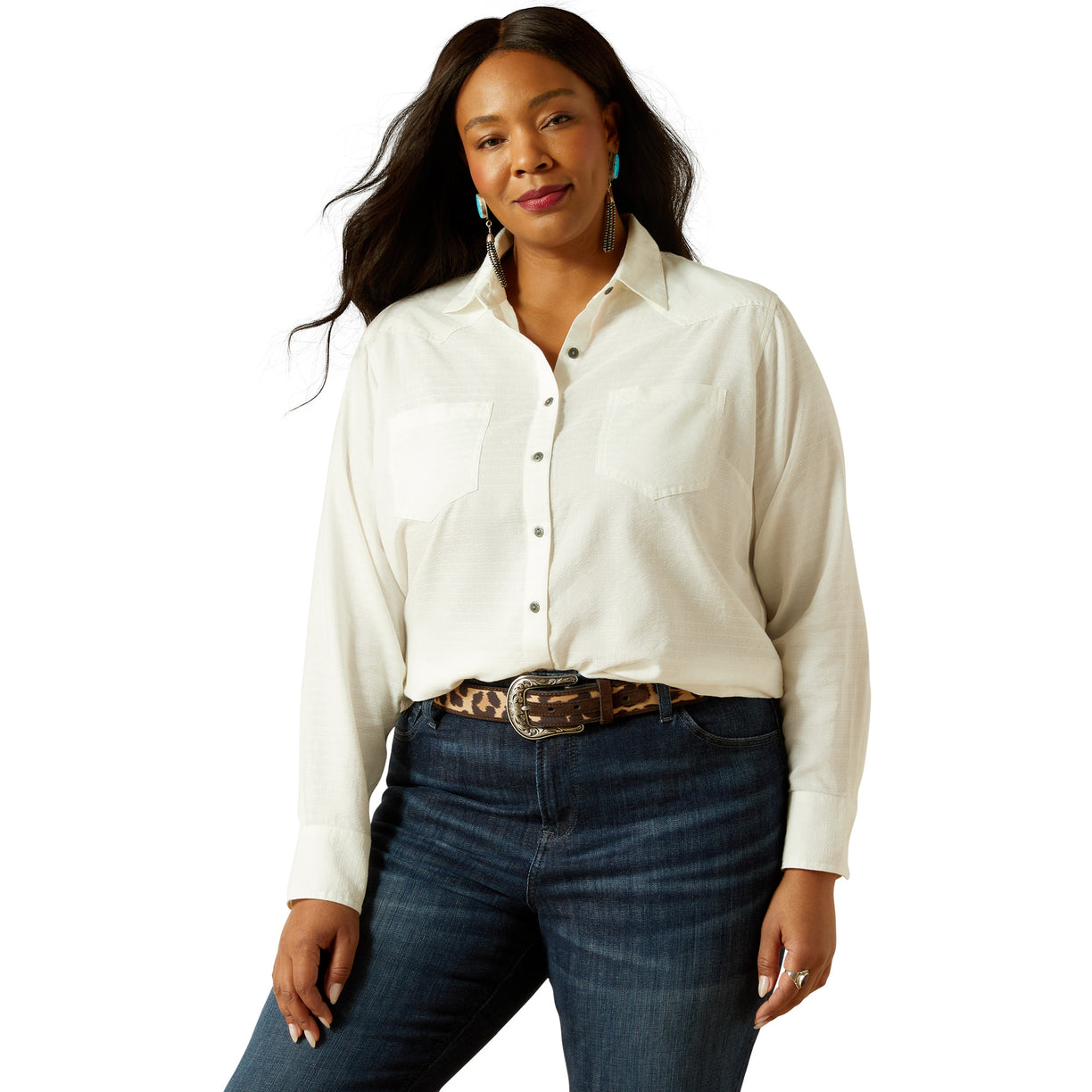 Woman wearing a white shirt and blue jeans with a belt on a white background