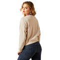 Woman wearing a beige sweater and blue jeans on a white background