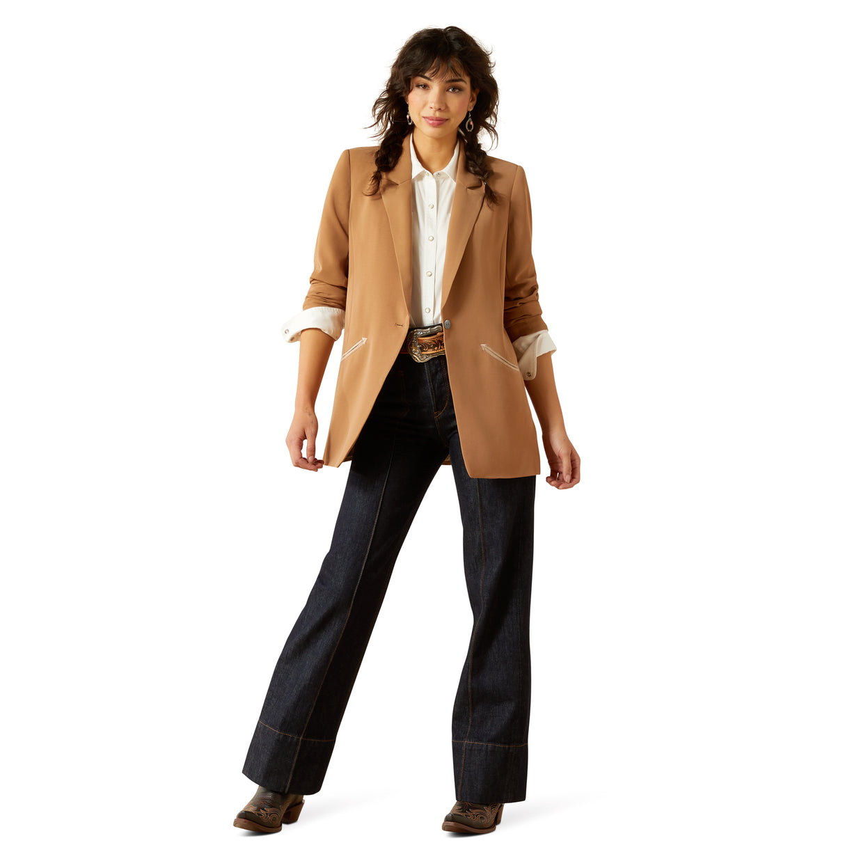 Woman wearing a tan blazer and dark pants on a white background