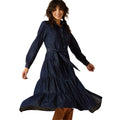 Woman wearing a long navy dress on a white background