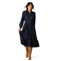 Woman wearing a navy dress with a white background