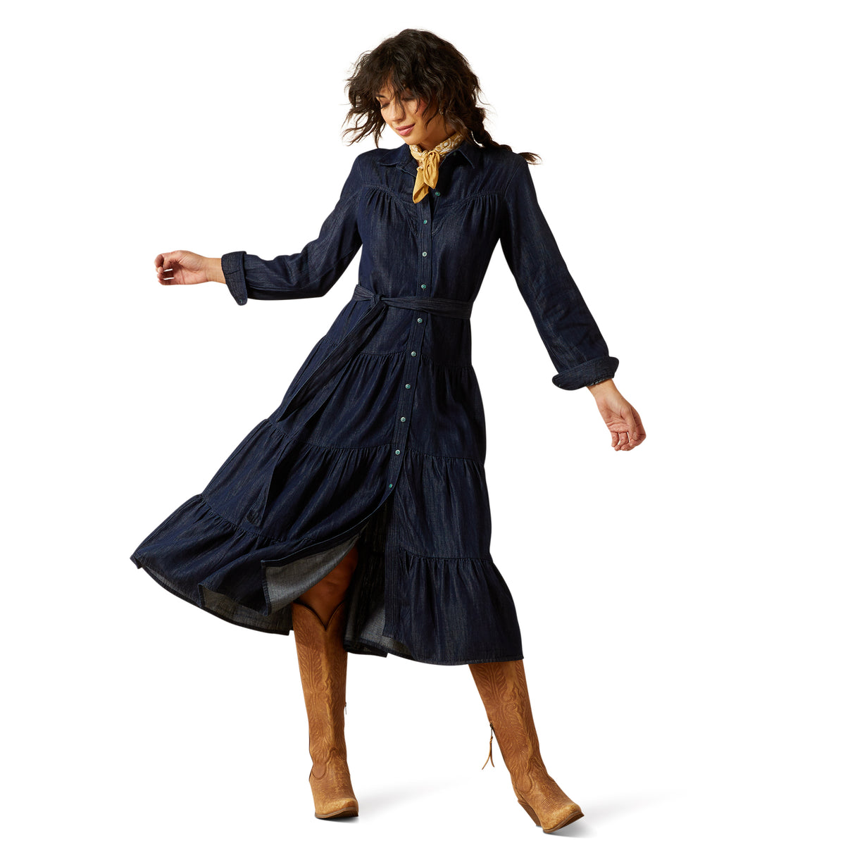 Woman wearing a navy blue dress with long sleeves and a belt, standing on a white background.