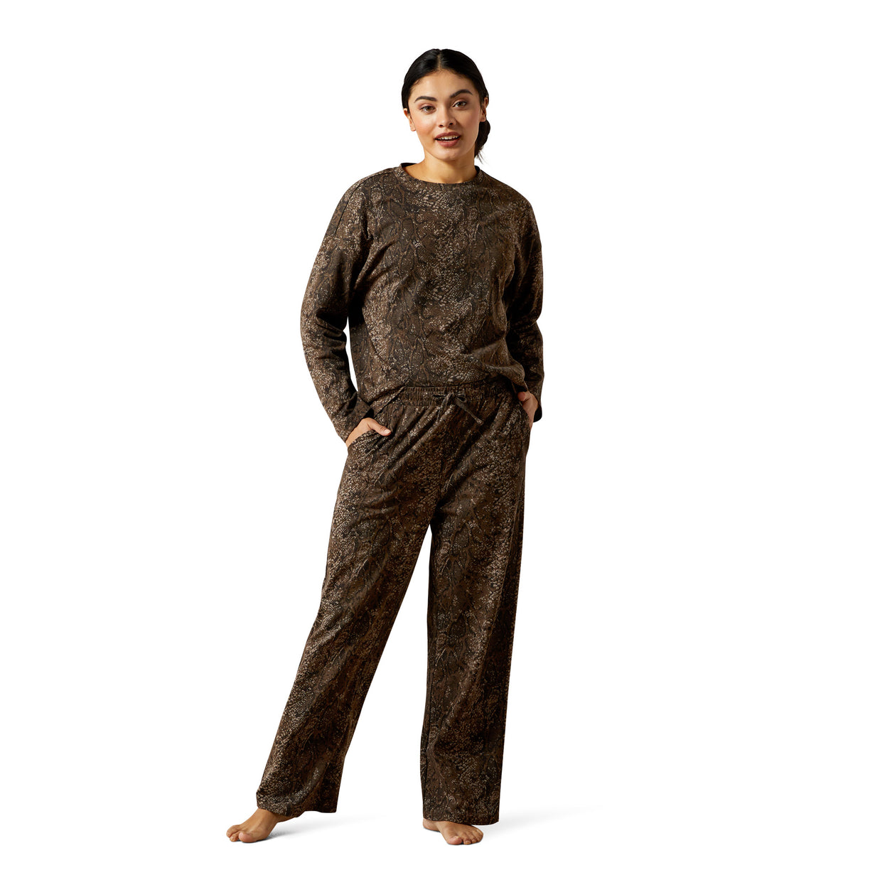 Woman wearing a brown patterned pajama set on a white background