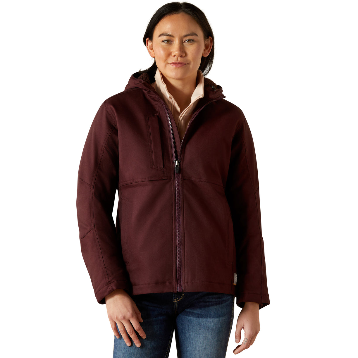 Woman wearing a maroon jacket with a white background