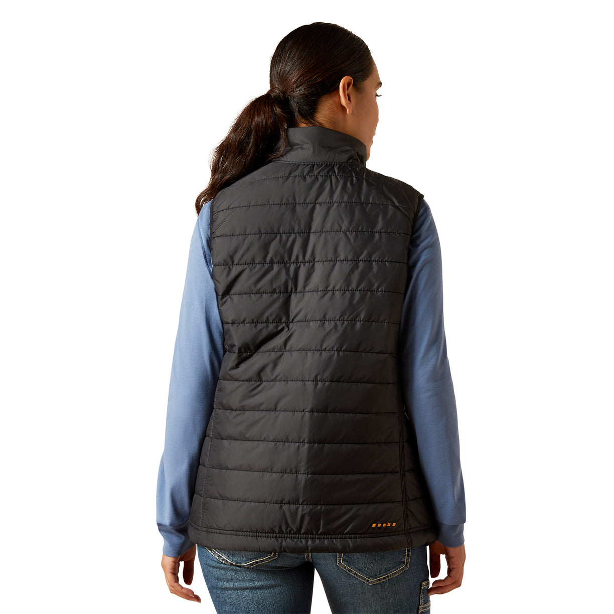 Person wearing a black puffer vest over a blue shirt on a white background