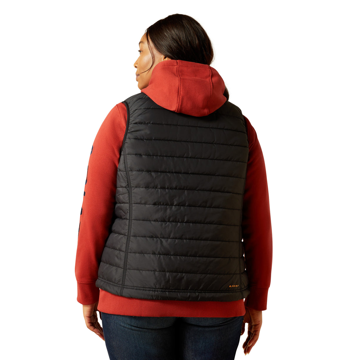 Person wearing a black puffer vest over a red shirt on a white background