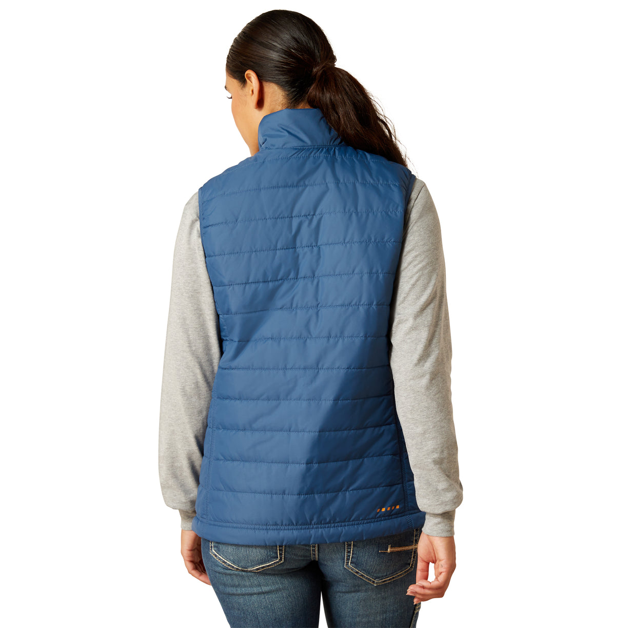 Person wearing a blue puffer vest over a gray shirt on a white background