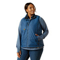 Woman wearing a blue quilted jacket on a white background