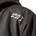 Close-up of a black jacket with 'Ariat' logo on the back