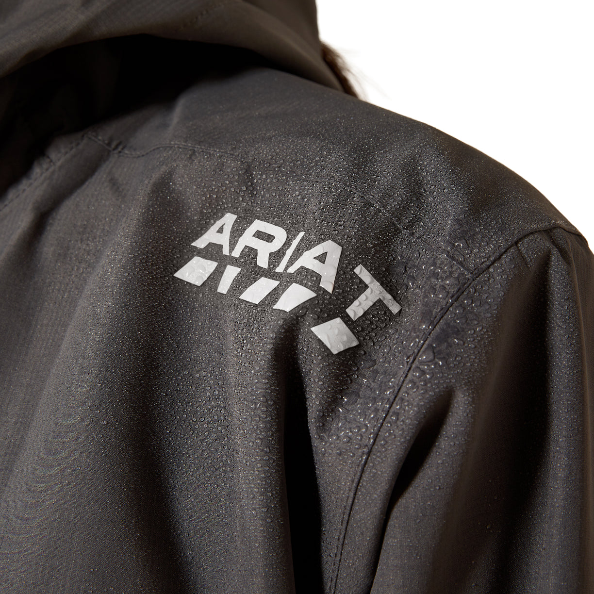 Close-up of a black jacket with 'Ariat' logo on the back