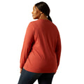 Person wearing a red long-sleeve shirt on a white background