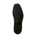 Black shoe sole with green tread pattern on a light gray background