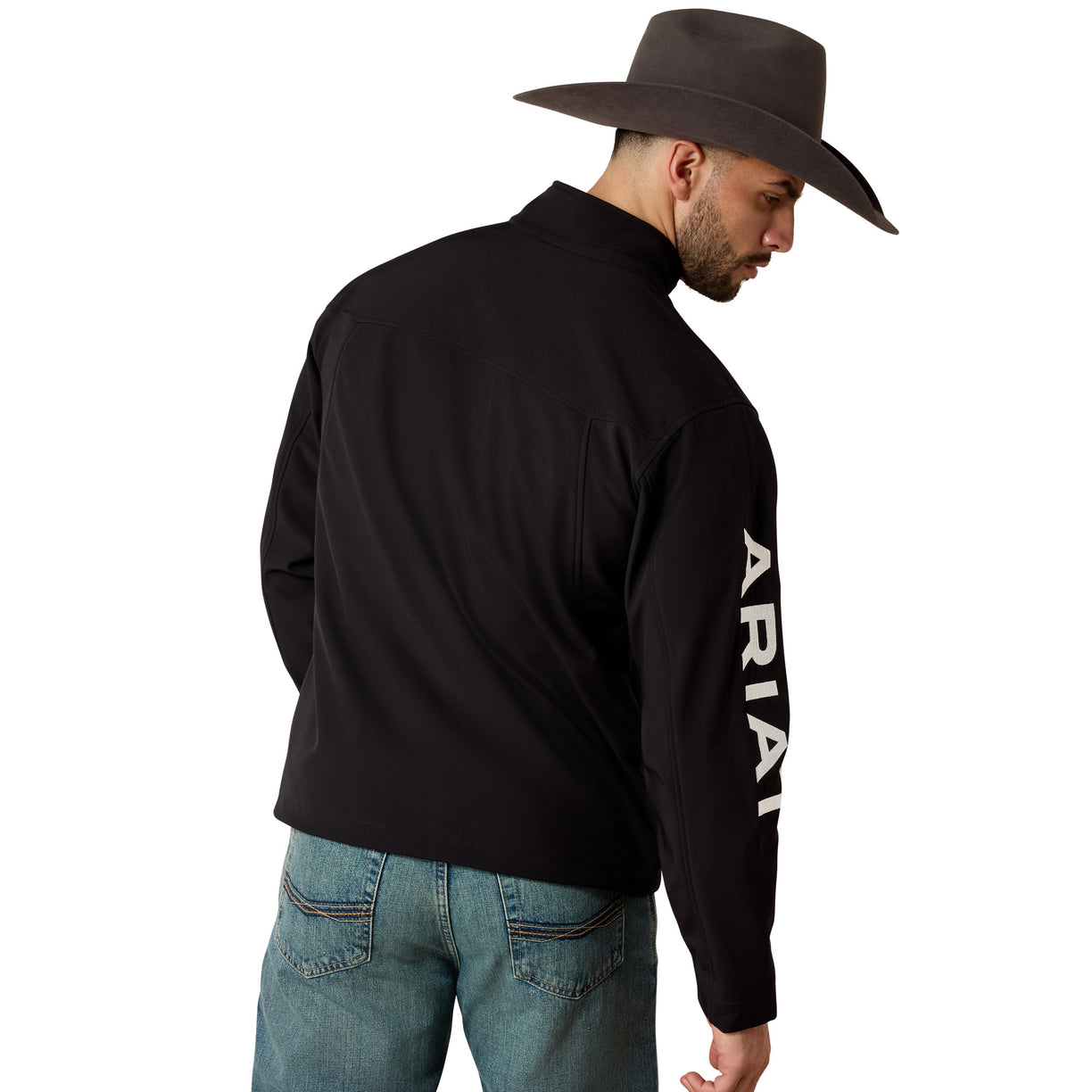 Man wearing a black long-sleeve shirt with 'Ariat' branding and a brown cowboy hat on a white background