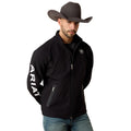 Man wearing a black jacket with 'Ariat' branding, a cowboy hat, and jeans on a white background